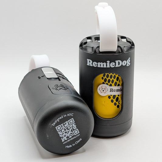 two black dog poop bag dispensers with white straps with RemieDog branding