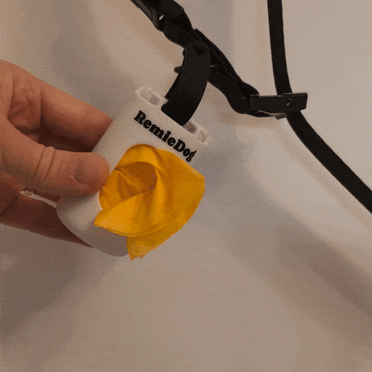 video of person pulling yellow compostable poop bags out of a remiedog poop bag container