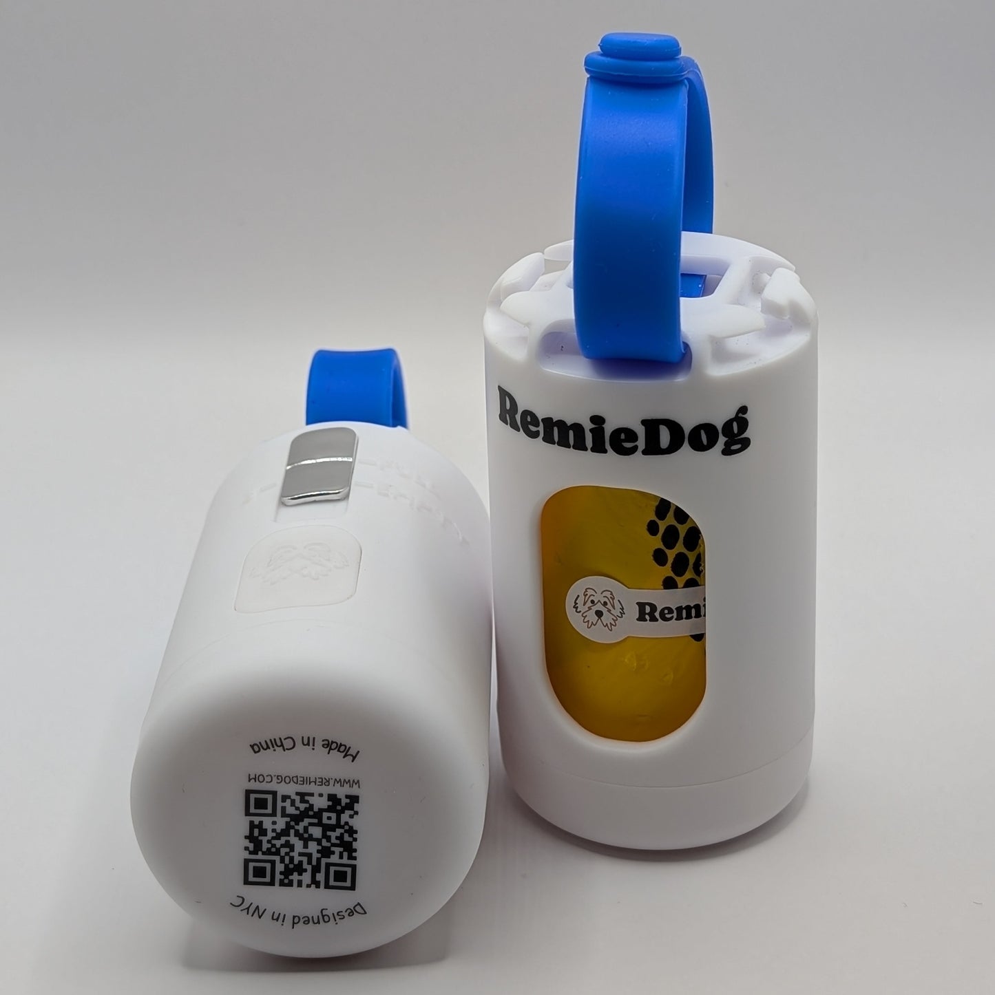 Two white dog poop bag holders with blue strap with RemieDog branding