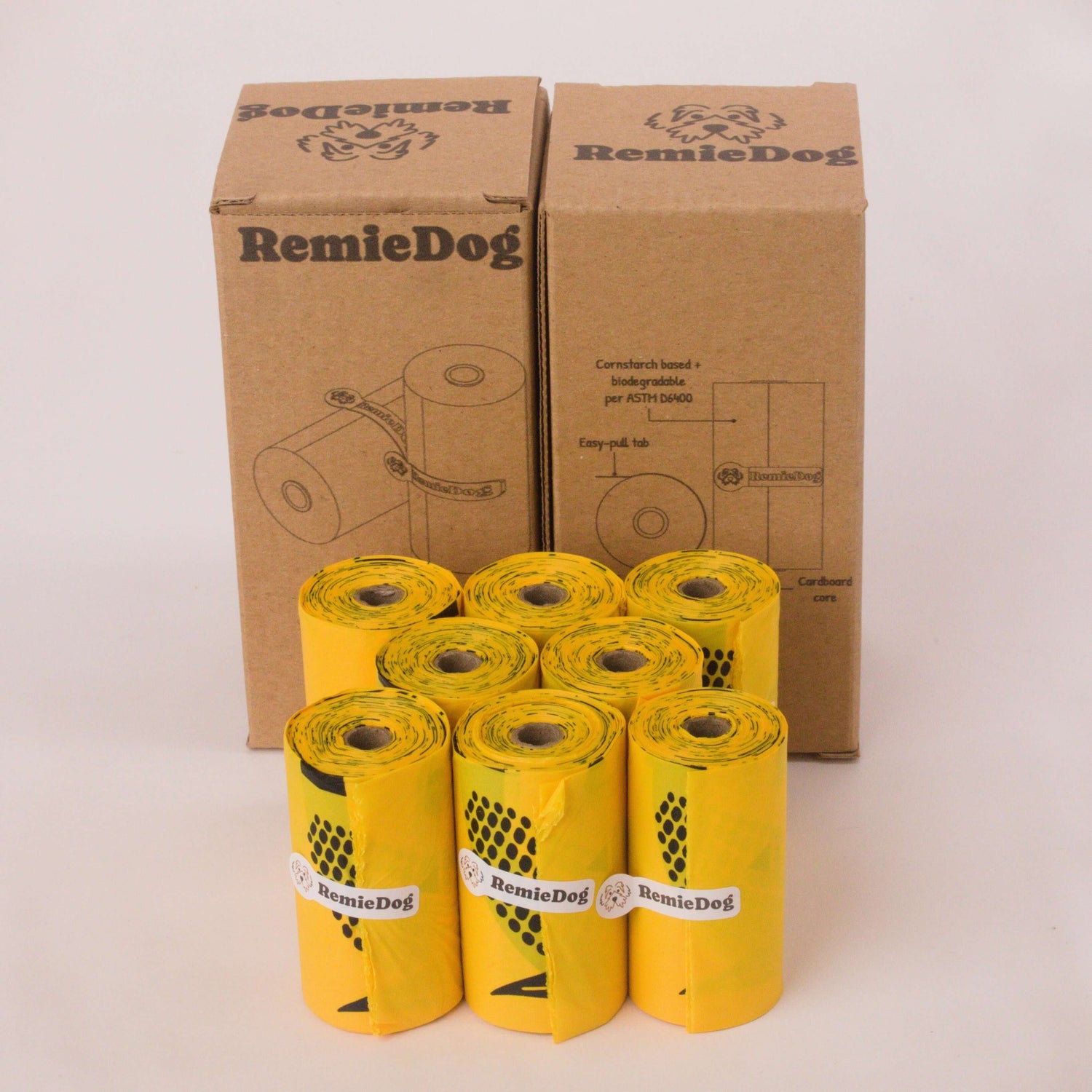 Yellow rolls of RemieDog dog waste bags with cardboard boxes on a white background