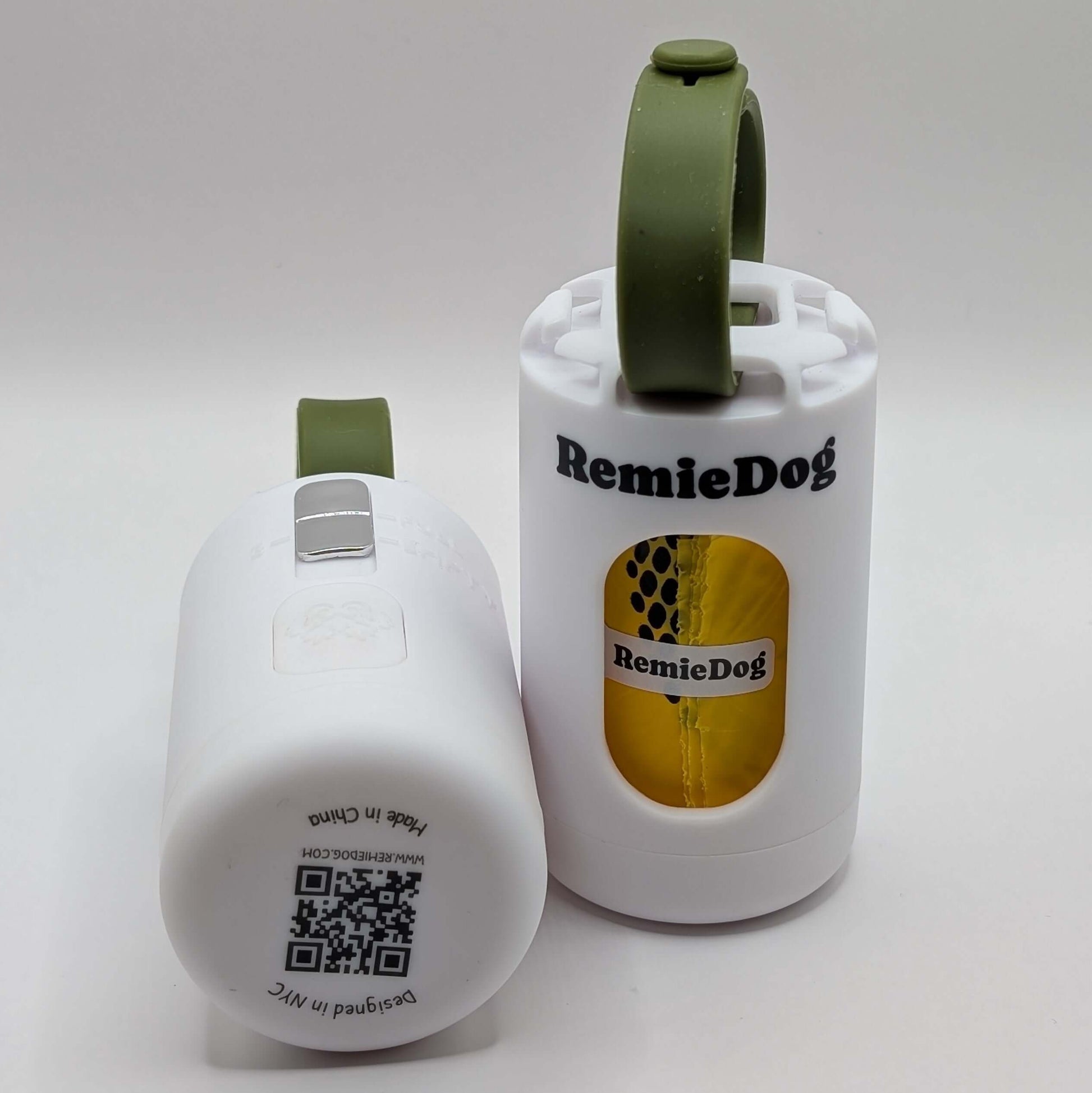 Two white dog poop bag holders with green strap with RemieDog branding