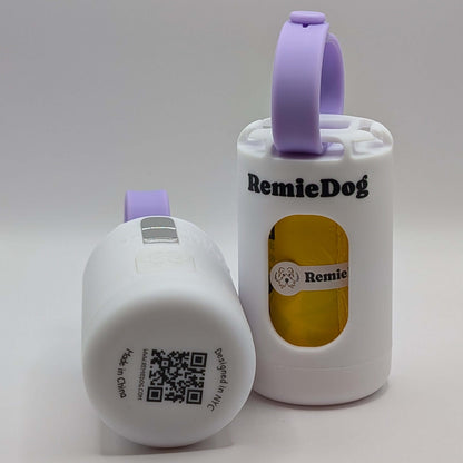 Two white dog poop bag holders with purple strap with RemieDog branding