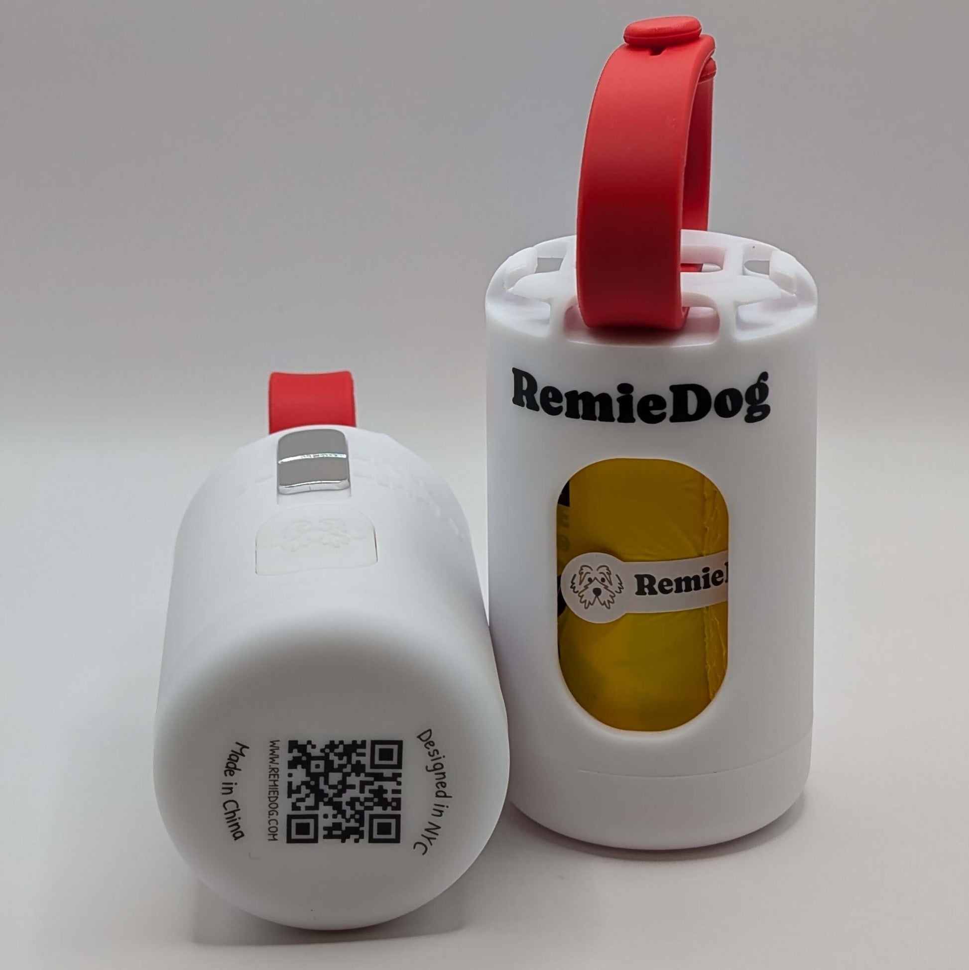 Two white dog poop bag holders with red strap with RemieDog branding