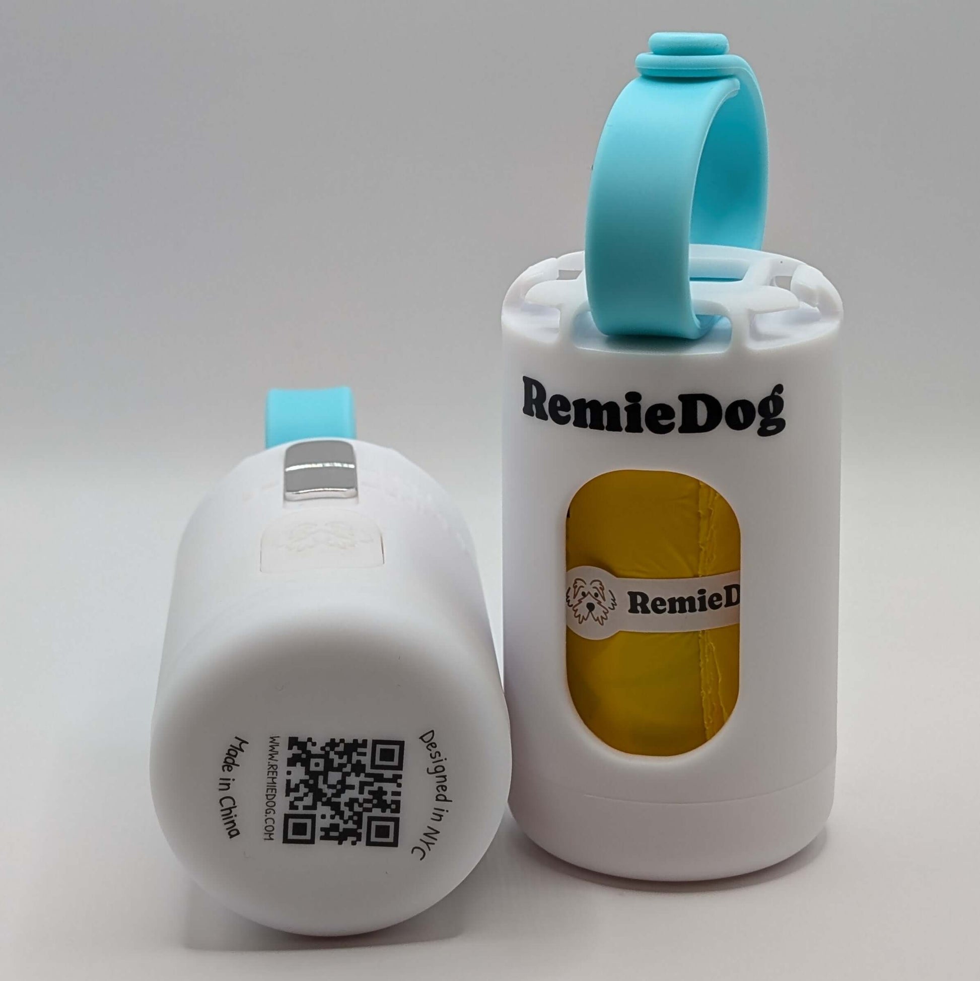 Two white dog poop bag holders with teal strap with RemieDog branding